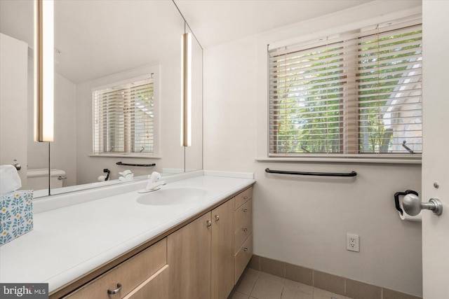 bathroom with vanity, tile floors, and toilet