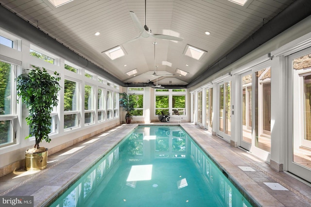 view of swimming pool with a skylight and ceiling fan