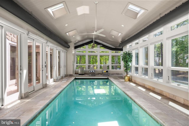 view of swimming pool with a skylight and ceiling fan