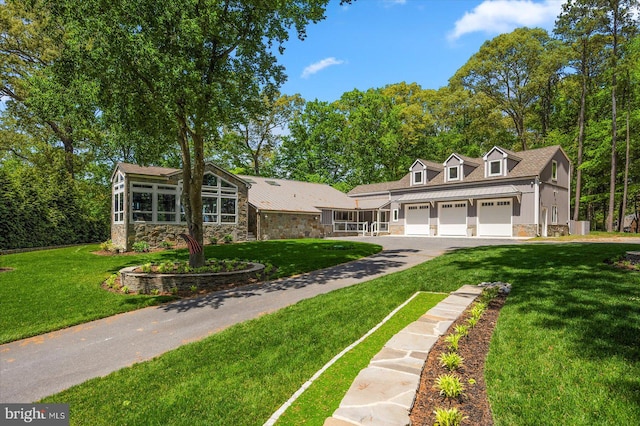 view of front of property with a garage and a front yard