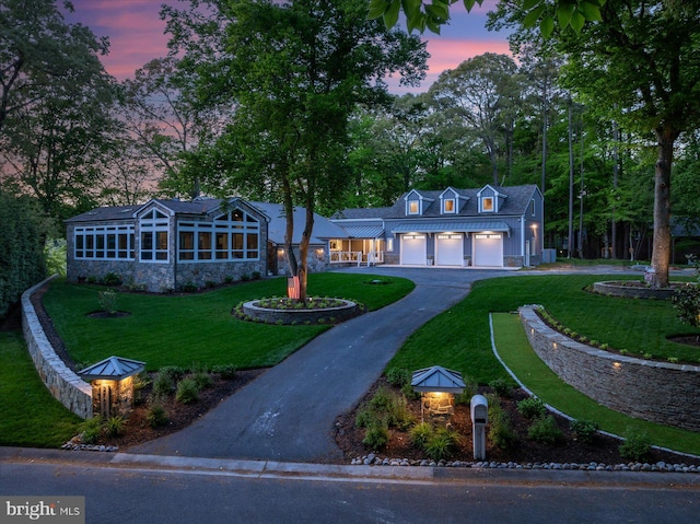 view of front of house with a garage and a lawn