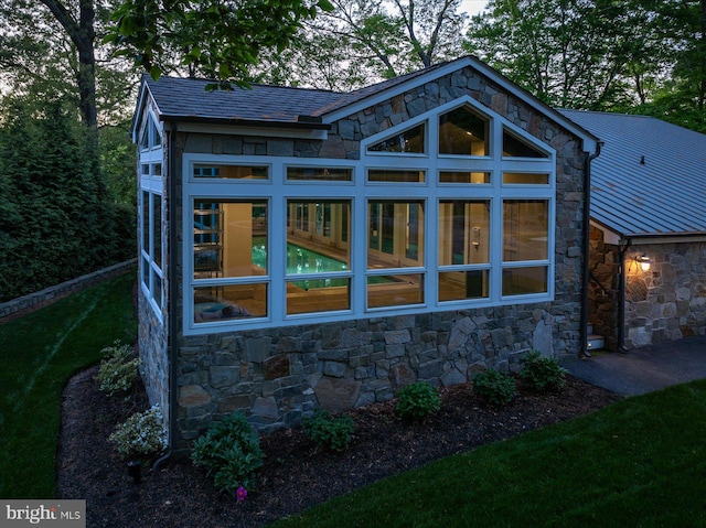 back of property featuring a sunroom