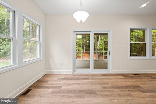 unfurnished dining area featuring light hardwood / wood-style flooring