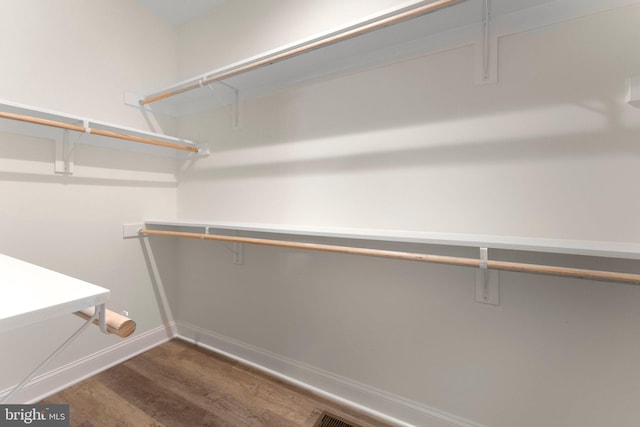 walk in closet featuring dark hardwood / wood-style flooring