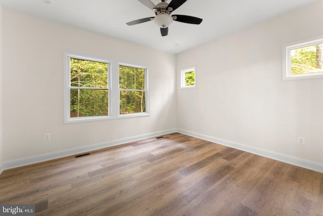 empty room with ceiling fan and wood-type flooring