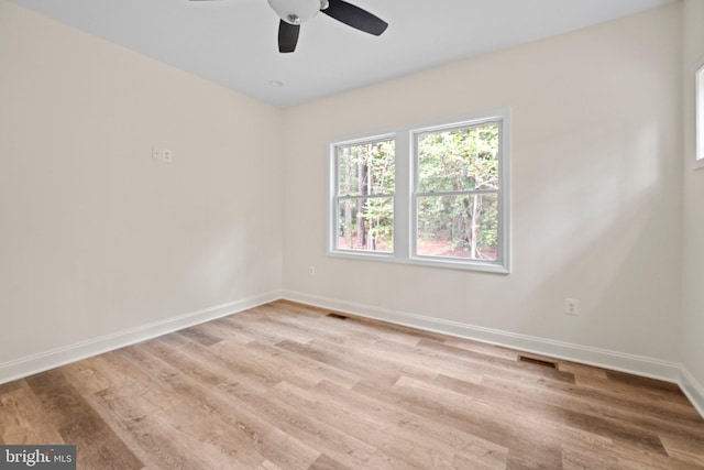 unfurnished room with ceiling fan and light wood-type flooring