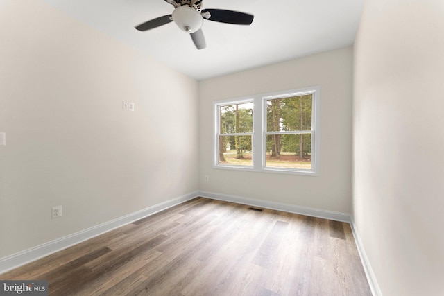 empty room with ceiling fan and hardwood / wood-style floors