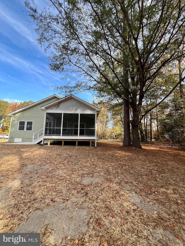 rear view of property with a sunroom