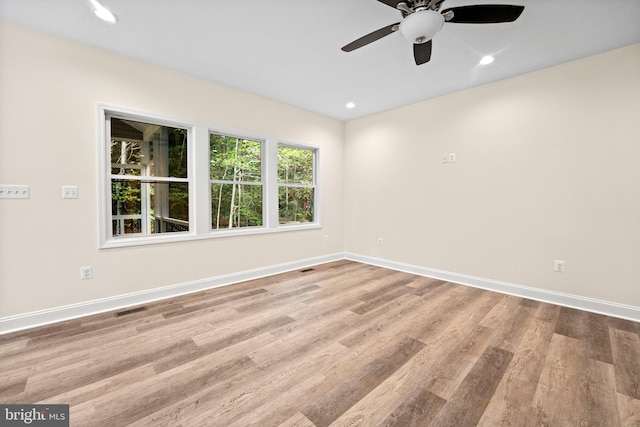 spare room featuring ceiling fan and light hardwood / wood-style floors