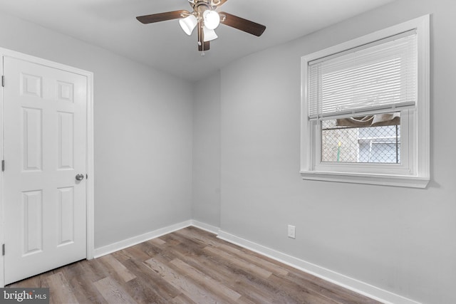 unfurnished room featuring light wood-type flooring and ceiling fan