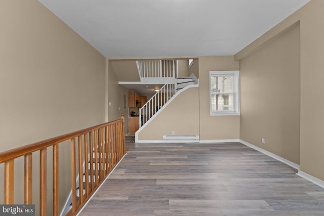 interior space featuring hardwood / wood-style floors and a baseboard heating unit