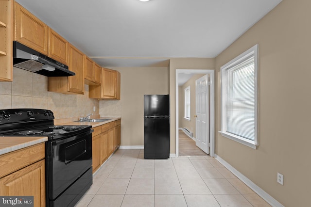 kitchen featuring black appliances, light tile patterned floors, sink, and tasteful backsplash