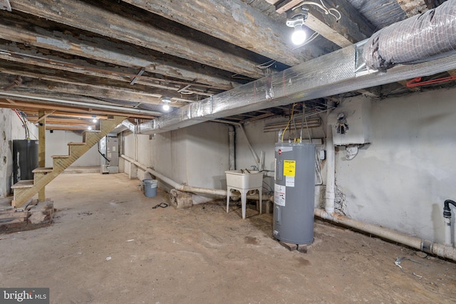 basement featuring electric water heater, sink, and water heater