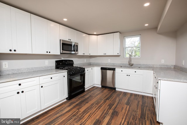 kitchen with sink, stainless steel appliances, dark hardwood / wood-style flooring, and white cabinetry