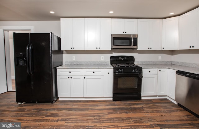 kitchen with white cabinets, black appliances, and dark wood-type flooring