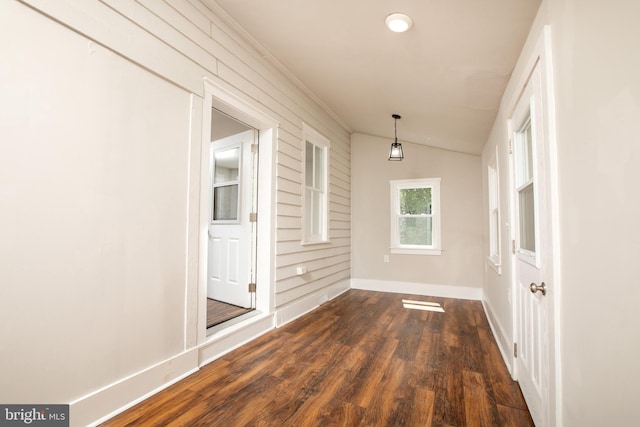 corridor featuring vaulted ceiling and hardwood / wood-style flooring