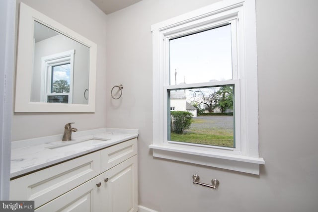 bathroom featuring a wealth of natural light and vanity