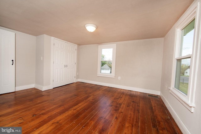 unfurnished room with hardwood / wood-style flooring