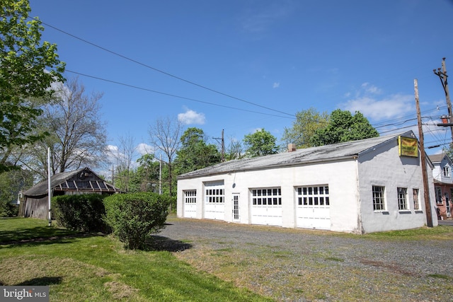 garage featuring a lawn