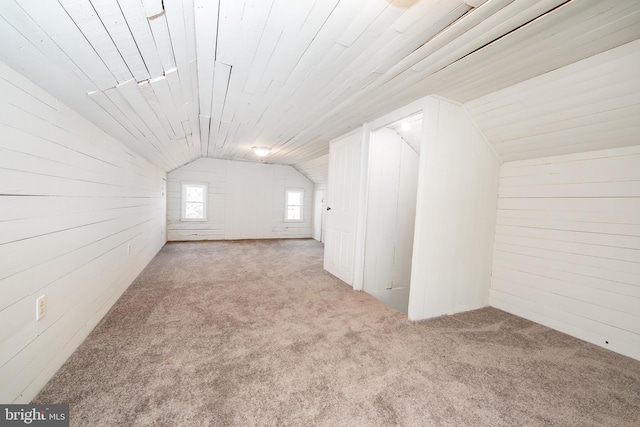 bonus room featuring vaulted ceiling and carpet flooring