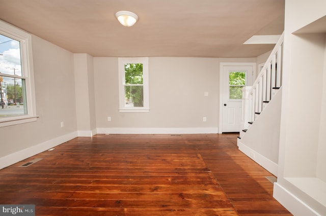 unfurnished room with plenty of natural light and hardwood / wood-style floors