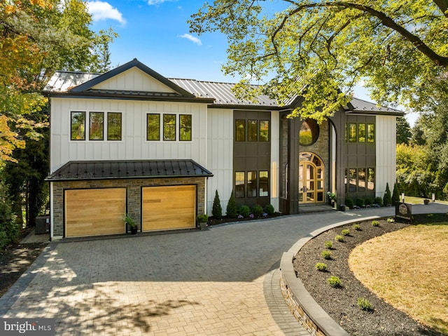 modern inspired farmhouse with cooling unit and a garage