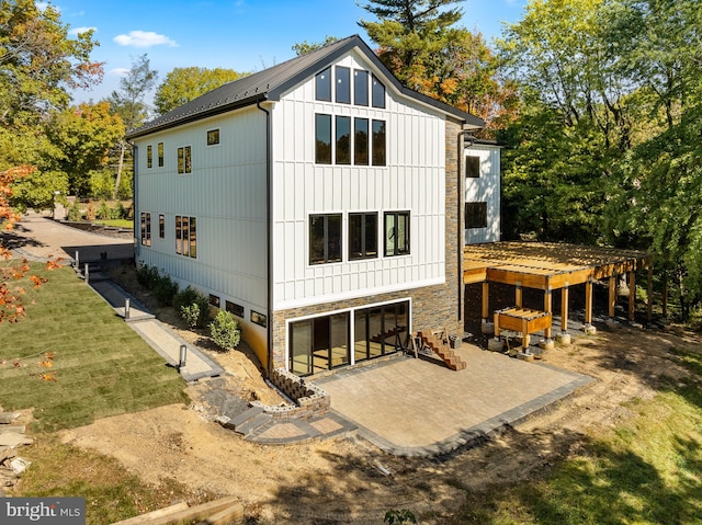 rear view of house with a patio and a yard