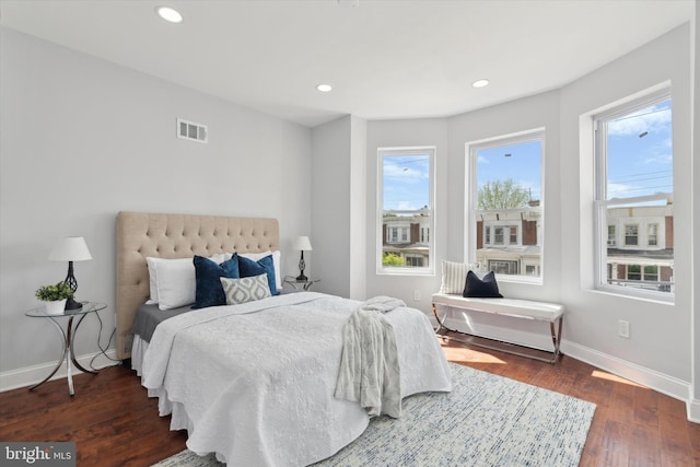 bedroom with dark wood-type flooring