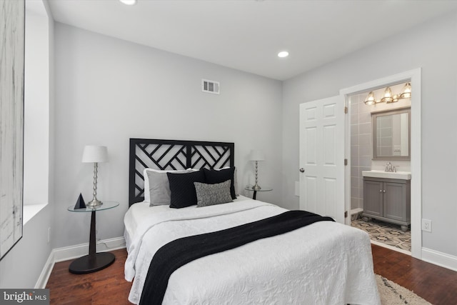 bedroom featuring hardwood / wood-style flooring, sink, and ensuite bathroom