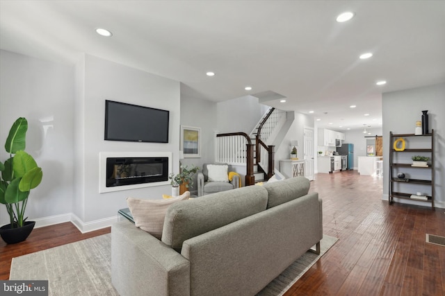 living room featuring dark wood-type flooring