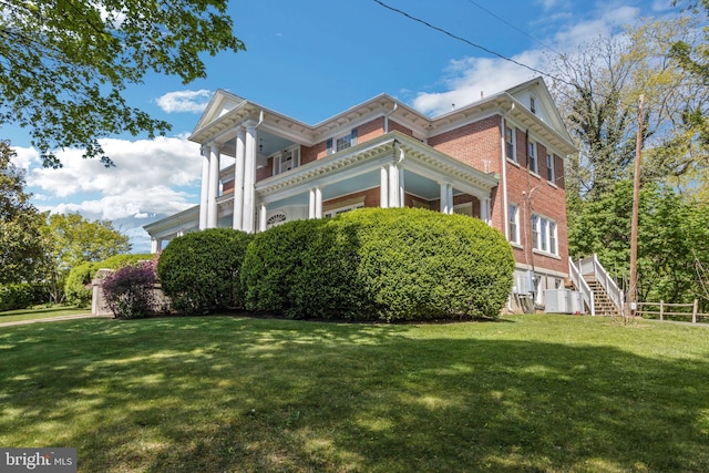 view of side of property with a lawn