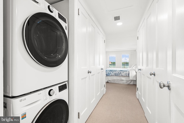 laundry room featuring visible vents, recessed lighting, carpet, stacked washer / dryer, and laundry area