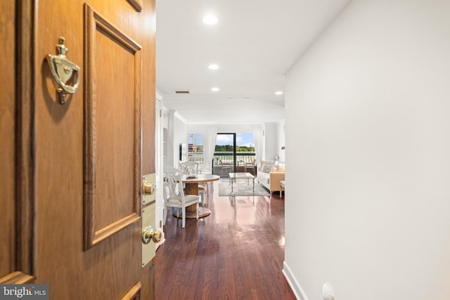 hallway featuring recessed lighting, visible vents, baseboards, and dark wood-type flooring