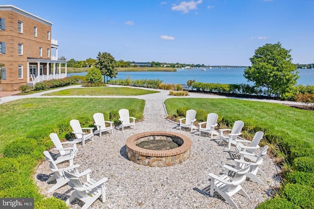 view of yard featuring a water view and an outdoor fire pit