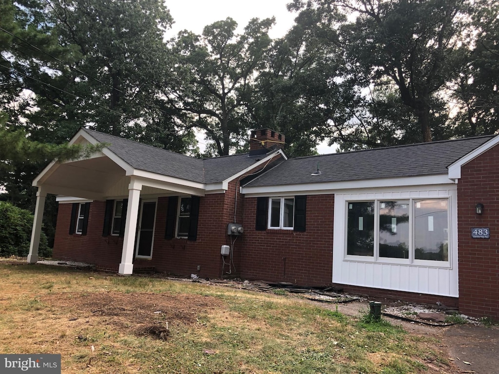 exterior space featuring a front yard and covered porch