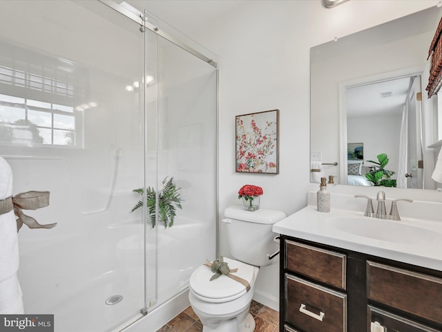 bathroom with a shower with shower door, toilet, tile floors, and large vanity