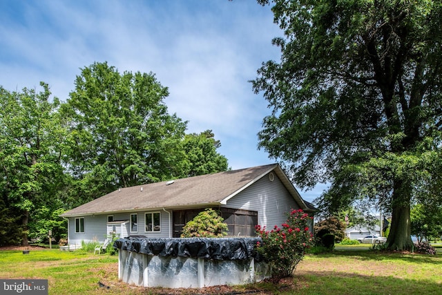 view of home's exterior featuring a yard and a covered pool