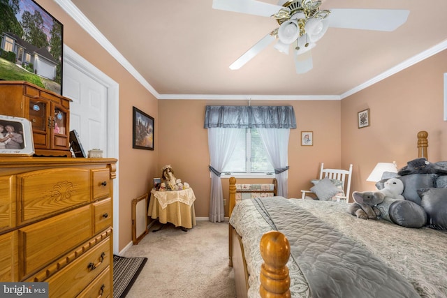 carpeted bedroom with ceiling fan and ornamental molding