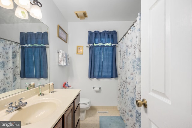 bathroom featuring tile patterned flooring, vanity, a shower with shower curtain, and toilet