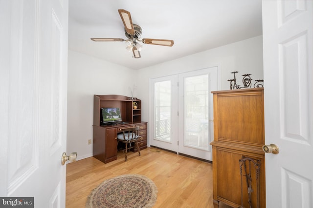 home office with ceiling fan and light hardwood / wood-style flooring