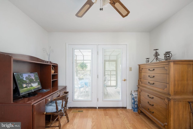 doorway featuring ceiling fan and light hardwood / wood-style flooring