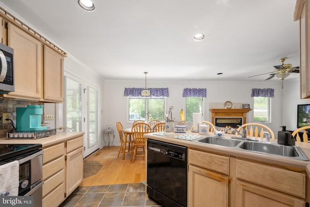 kitchen featuring ceiling fan, sink, dishwasher, light brown cabinets, and decorative light fixtures