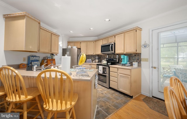 kitchen with ornamental molding, a breakfast bar, stainless steel appliances, dark wood-type flooring, and light brown cabinets