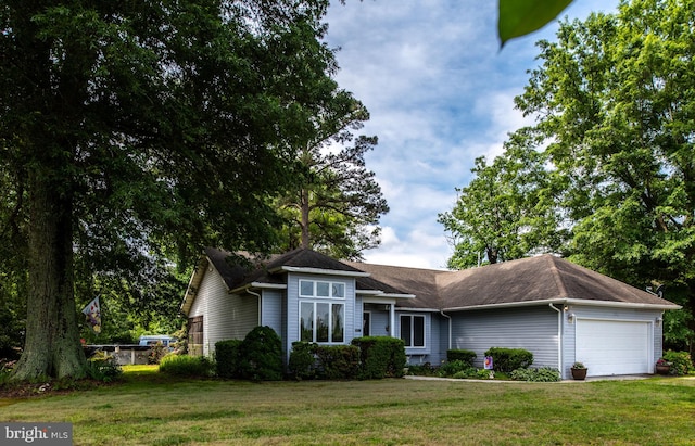 single story home with a garage and a front lawn