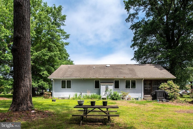 back of property featuring a lawn