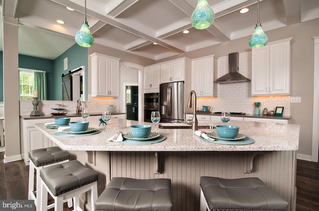 kitchen featuring wall chimney exhaust hood, coffered ceiling, dark hardwood / wood-style flooring, and beam ceiling