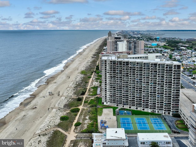 bird's eye view with a water view and a beach view