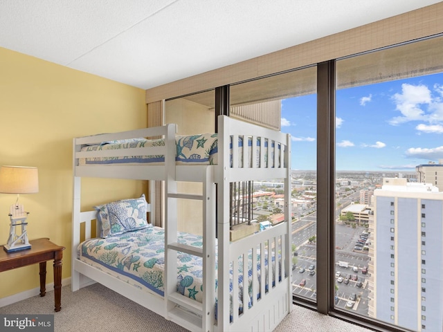 bedroom featuring a textured ceiling and carpet flooring