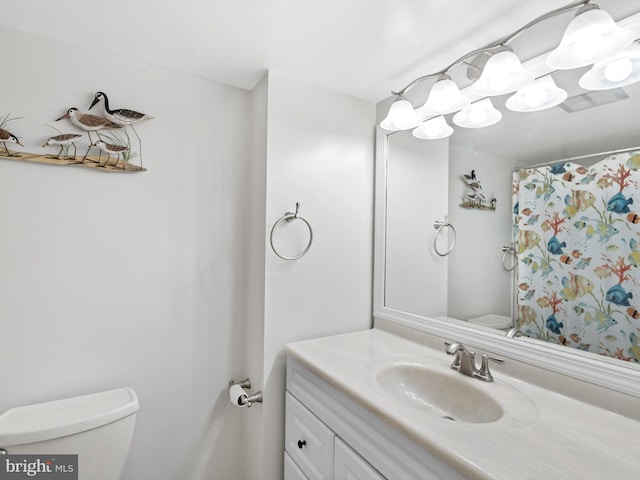 bathroom with vanity, toilet, and a shower with shower curtain