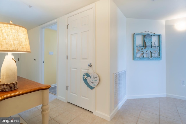 hall featuring light tile floors